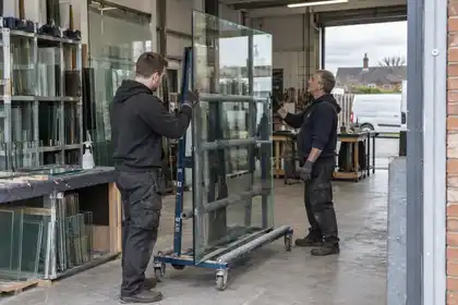 Local glazing staff checking a supported pane in their workshop